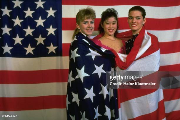 Figure Skating: World Championships, Portrait of USA Tonya Harding, Kristi Yamaguchi, and Nancy Kerrigan with USA flag at Olympia Eisstadion, Munich,...