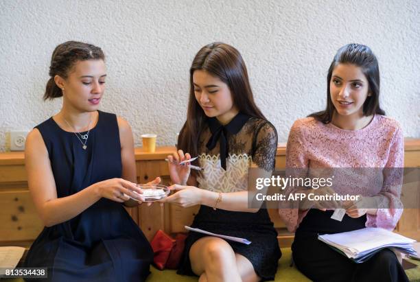 Women taste chocolate during a lesson at Switzerland's last finishing school Institut Villa Pierrefeu on June 26, 2017 in Glion. Eight women sit...