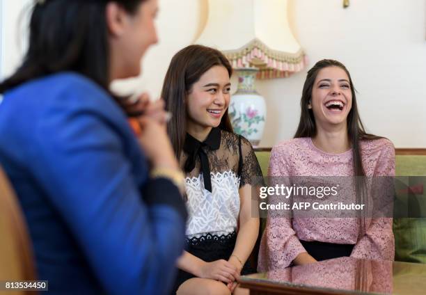 Women laugh during a lesson at the Switzerland's last finishing school Institut Villa Pierrefeu on June 26, 2017 in Glion. Eight women sit primly...
