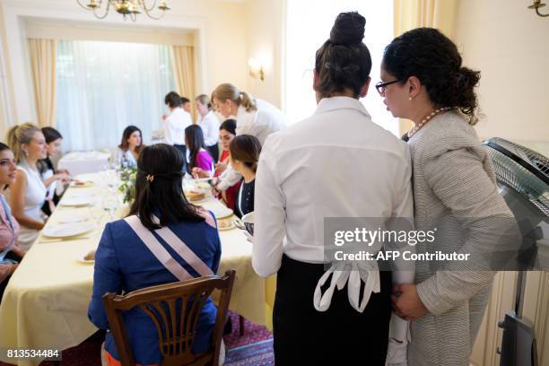Women attend a lesson at the Switzerland's last finishing school Institut Villa Pierrefeu on June 26, 2017 in Glion. Eight women sit primly around an...