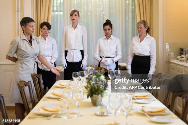 Women attend a lesson at the Switzerland's last finishing school Institut Villa Pierrefeu on June 26, 2017 in Glion. Eight women sit primly around an...