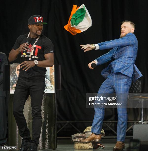 Conor McGregor throws the Irish flag at Floyd Mayweather after Mayweather tried to give it to him. Floyd Mayweather and Conor McGregor in town on a...