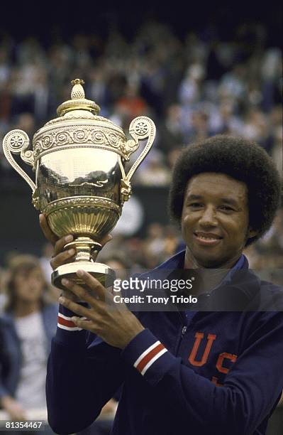 Tennis: Wimbledon, Closeup of American tennis player Arthur Ashe, victorious with trophy after winning tournament at All England Club, London, GBR...