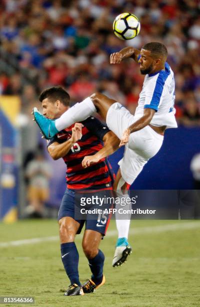 Defender Eric Lichaj of the United States and defender Antoine Jean-Baptiste of Martinique vie for the ball during the first half of their Group B...