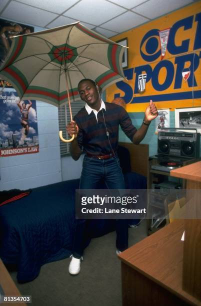 College Basketball: Casual portrait of North Carolina Michael Jordan dancing with umbrella in dorm room at University of North Carolina campus,...