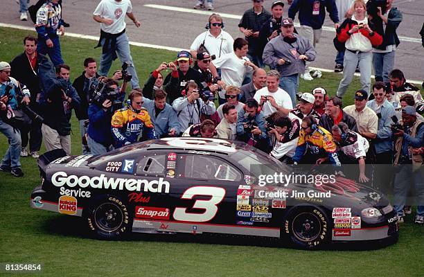 Auto Racing: NASCAR Daytona 500, Dale Earnhardt victorious with crew after winning race, Daytona, FL 2/15/1998