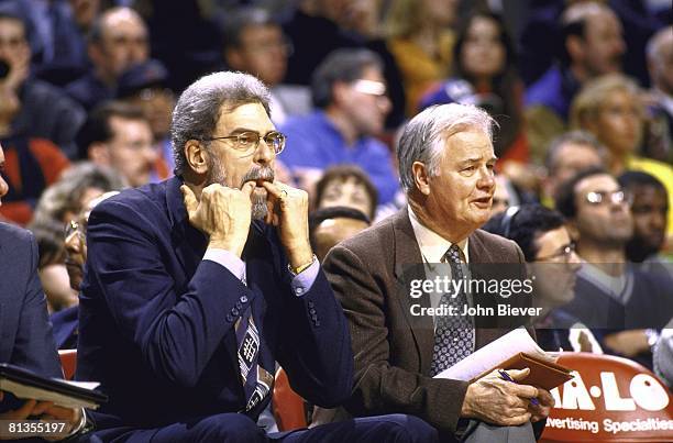 Basketball: Closeup of Chicago Bulls coach Phil Jackson whistling from sidelines bench with assistant coach Tex Winter during game vs Philadelphia...