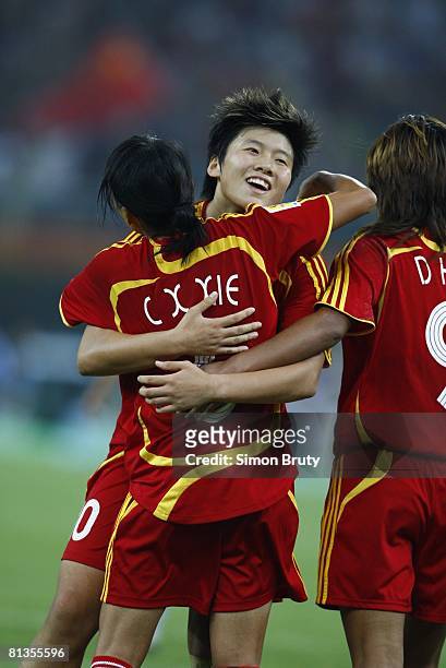 Soccer: World Cup, China Xie Caixia victorious with Ma Xiaoxu after scoring 2nd goal of game vs New Zealand, Tianjin, China 9/20/2007