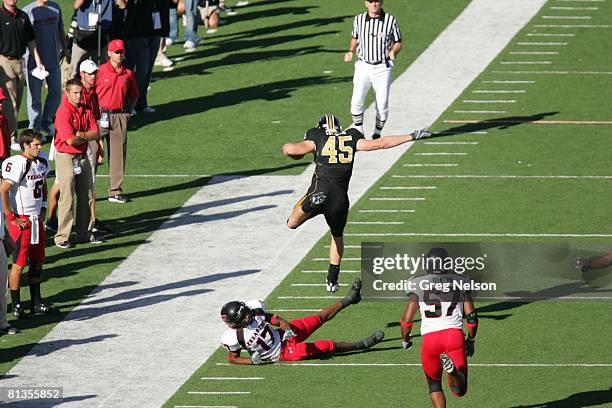 College Football: Aerial rear view of Missouri Chase Coffman in action, rushing and jumping over Texas Tech Chris Parker , Columbia, MO