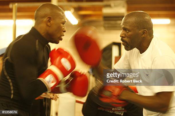 Junior Middleweight Boxing: Closeup of Floyd Mayweather Jr, training with uncle and trainer Roger Mayweather during workout for Oscar De La Hoya...