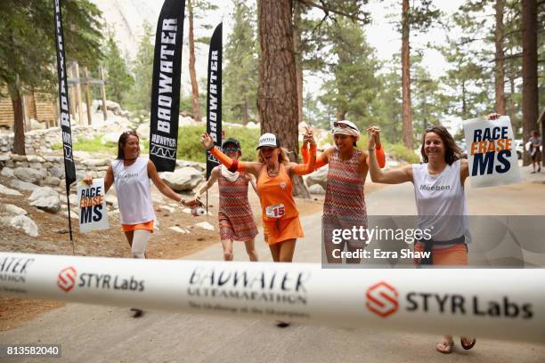 Shannon Farar-Griefer crosses the finish line with her support crew in the STYR Labs Badwater 135 on July 12, 2017 in Death Valley, California....