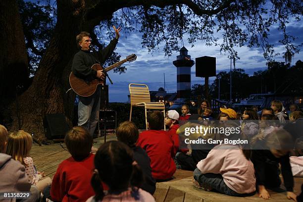 Golf: Verizon Heritage Week, Gregg Russell performing folk sing-a-long to children under 200-year-old Liberty Oak tree at Harbour Town Yacht Basin on...