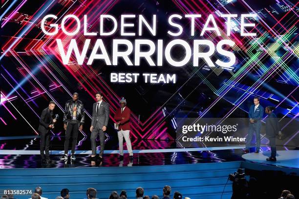 Player Steph Curry accepts the Best Team award on behalf of the NBA champion Golden State Warriors with host Peyton Manning , actor Samuel L. Jackson...