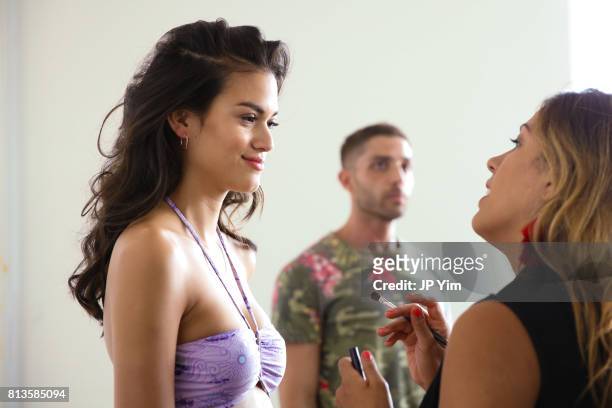 Model prepares backstage at Thorsun Men's and Women's Spring/Summer 2018 presentation on July 12, 2017 in New York City.