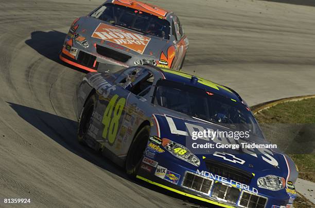 Auto Racing: NASCAR Subway 500, Jimmie Johnson and Tony Stewart in action during race, Martinsville, VA