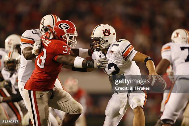 College Football: Auburn QB Brandon Cox in action, under pressure vs Georgia, Athens, GA