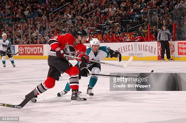 Hockey: Buffalo Sabres Henrik Tallinder in action, taking shot vs San Jose Sharks Nils Ekman , Buffalo, NY 12/2/2005