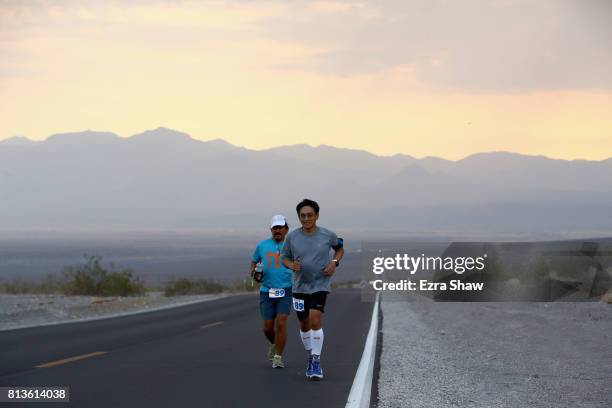 Franco Soriano runs with a member of his support crew during the STYR Labs Badwater 135 on July 12, 2017 in Death Valley, California. The start of...