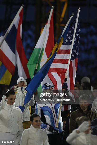 Closing Ceremony: 2006 Winter Olympics, USA speed skating athlete Joey Cheek victorious, carrying USA flag after games at Stadio Olimpico, Turin,...