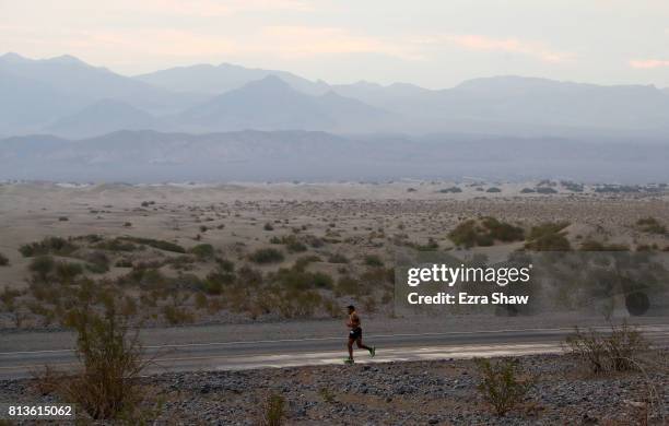 An athlete runs past the Mesquite Flat Sand Dunes during the STYR Labs Badwater 135 on July 12, 2017 in Death Valley, California. The start of the...