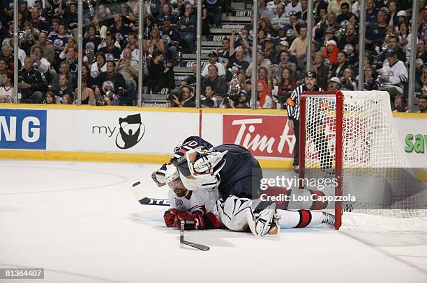 Hockey: NHL Finals, Carolina Hurricanes Justin Williams lying on top of Edmonton Oilers goalie Jussi Markkanen during Game 6, Edmonton, Canada...