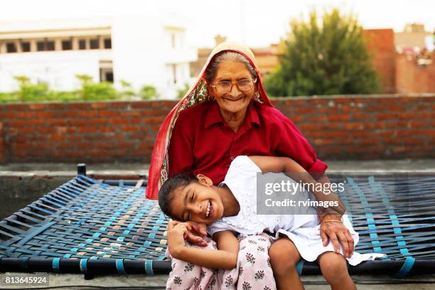 loving granddaughter and grandmother - indian grandparents stock pictures, royalty-free photos & images