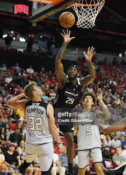 JaKarr Sampson of the Sacramento Kings is fouled by Tim Kempton of the Milwaukee Bucks as D.J. Wilson of the Bucks looks on during the 2017 Summer...