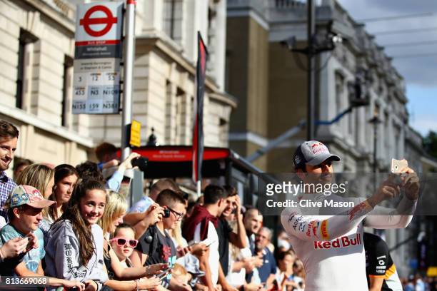 Carlos Sainz of Spain and Scuderia Toro Rosso takes a selfie with fans during F1 Live London at Trafalgar Square on July 12, 2017 in London, England....