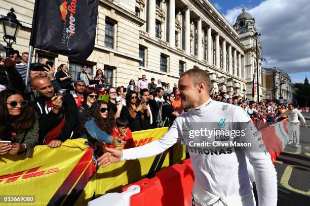 Valtteri Bottas of Finland and Mercedes GP greets fans during F1 Live London at Trafalgar Square on July 12, 2017 in London, England. F1 Live London,...
