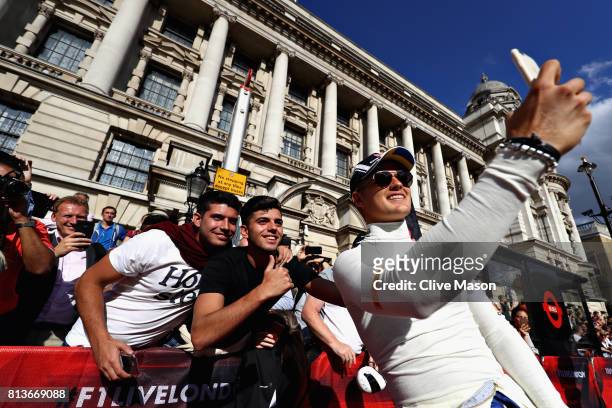 Marcus Ericsson of Sweden and Sauber F1 takes a selfie with fans during F1 Live London at Trafalgar Square on July 12, 2017 in London, England. F1...