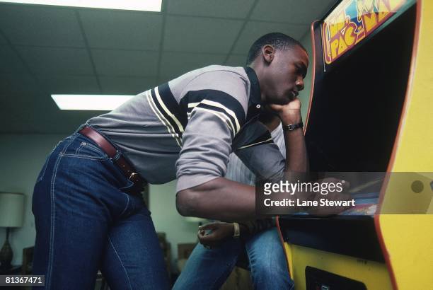 College Basketball: Casual portrait of North Carolina Michael Jordan playing MS, PACMAN video arcade game at University of North Carolina, Chapel...