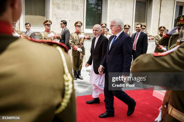 German Federal President Frank-Walter Steinmeier walks with Afghan President Mohammad Ashraf Ghani at the Gulkhana Palace on July 13, 2017 in Kabul,...