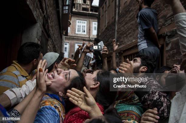 Relatives of a local rebel Sajad Gilkar wail, during his funeral procession Wednesday, July 12, 2017 in Srinagar, Indian-administered Kashmir, India....