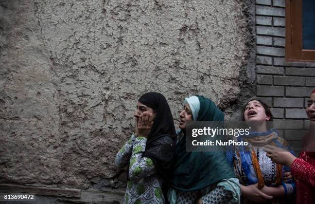 Relatives of a local rebel Sajad Gilkar wail, during his funeral procession Wednesday, July 12, 2017 in Srinagar, Indian-administered Kashmir, India....