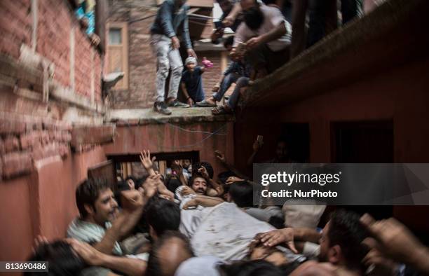 Kashmiri people carry the body of a local rebel Sajad Gilkar, during his funeral Wednesday, July 12, 2017 in Srinagar, Indian-administered Kashmir,...