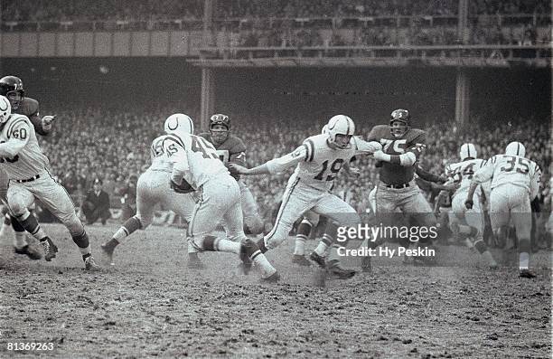 Football: NFL Championship, Baltimore Colts QB Johnny Unitas in action, making hand off to L,G, Dupre during game vs New York Giants, Bronx, NY