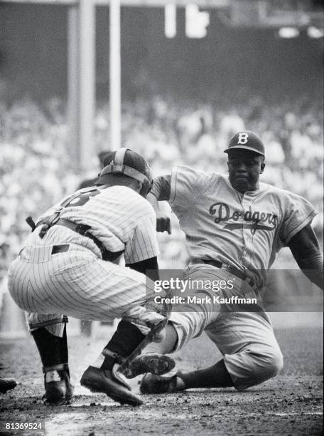 Baseball: World Series, Brooklyn Dodgers Jackie Robinson in action, home plate steal vs New York Yankees Yogi Berra , Safe at home after stolen base,...