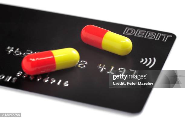 credit debit card with prescription drugs - prescription drug costs stock pictures, royalty-free photos & images