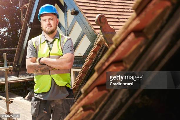 proud construction worker on roof scaffold - roofing contractor stock pictures, royalty-free photos & images