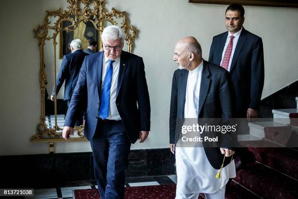 German Federal President Frank-Walter Steinmeier walks with Afghan President Mohammad Ashraf Ghani at the Gulkhana Palace on July 13, 2017 in Kabul,...