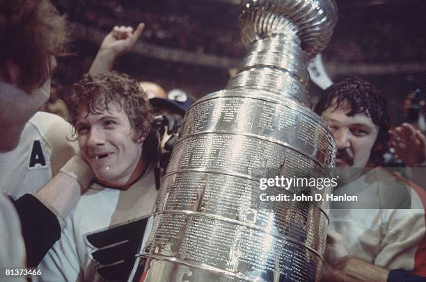 Hockey: NHL Finals, Closeup of Philadelphia Flyers Bobby Clarke victorious with Stanley Cup trophy after winning Game 6 and series vs Boston Bruins,...