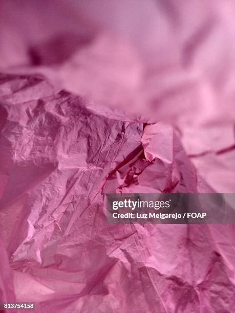 full frame of pink wrapping paper - luz brillante stock-fotos und bilder