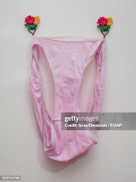 pink underwear hanging on wall - lifestyle stock pictures, royalty-free photos & images