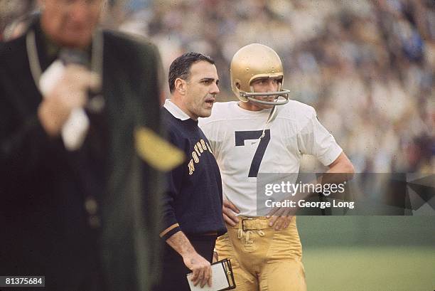 College Football: Notre Dame QB Joe Theismann on sidelines with coach Ara Parseghian during game vs USC, Los Angeles, CA