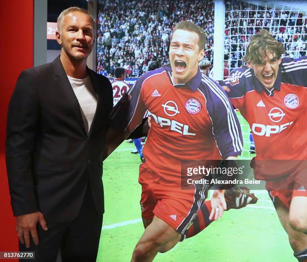 Former FC Bayern Muenchen player Patrik Andersson poses in front of his photograph during the opening ceremony of the special exhibition called...