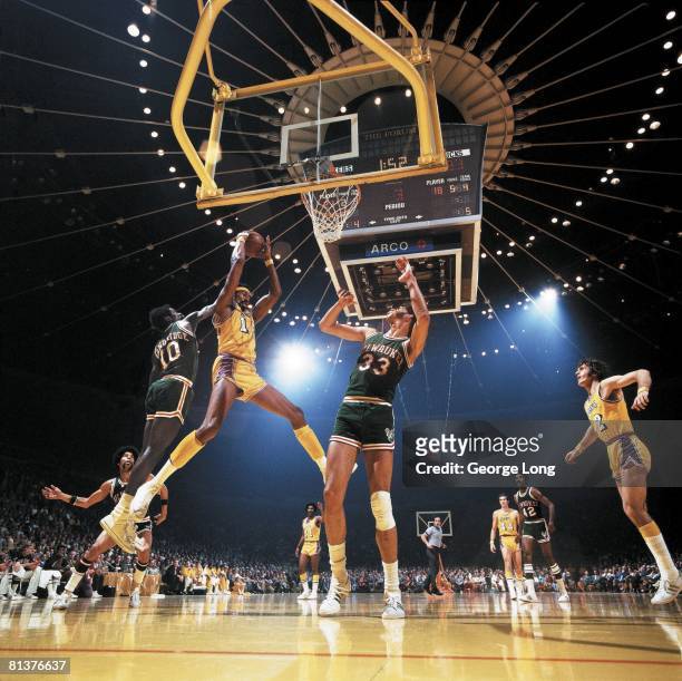 Basketball: NBA Playoffs, Los Angeles Lakers Wilt Chamberlain in action vs Milwaukee Bucks Kareem Abdul-Jabbar and Bob Dandridge , View of scoreboard...