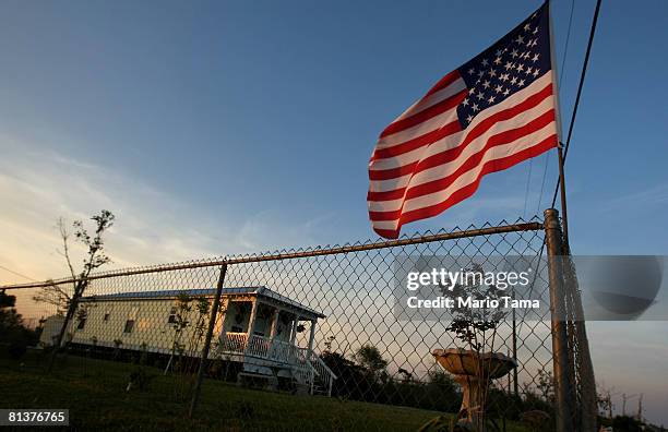 An American flag flies above a "Mississippi cottage" June 2, 2008 in Waveland, Mississippi. The cottage is one of close to 2,400 cottages the...