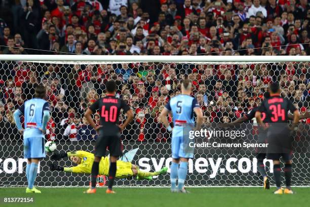 Andrew Redmayne of Sydney FC saves a penalty kick attempt by Danny Welbeck of Arsenal during the match between Sydney FC and Arsenal FC at ANZ...