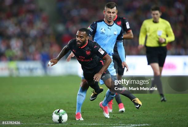 Alexandre Lacazette of Arsenal is tackled by Christopher Zuvela of Sydney FC during the match between Sydney FC and Arsenal FC at ANZ Stadium on July...