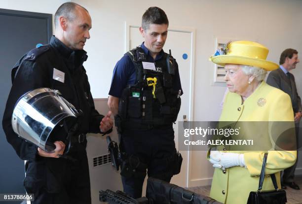 Britain's Queen Elizabeth II is pictured during a visit open the new headquarters of the Metropolitan Police, New Scotland Yard, in central London on...